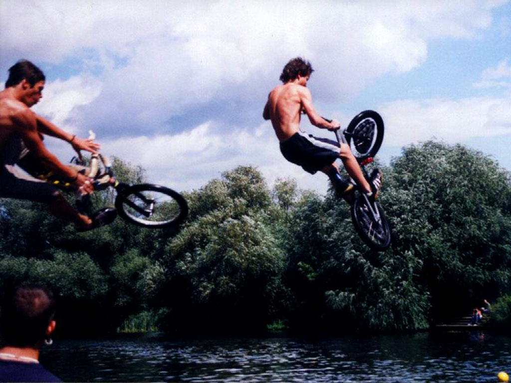Jumping into a river with bike